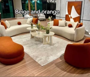 Beige and terracotta orange living room — curved sofas with rounded accent chairs