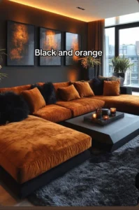 Black and burnt orange living room — large velvet sectional, warm cove lighting, dark walls
