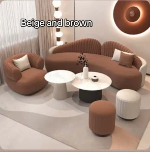 Curved brown velvet sofa with beige marble side tables and globe lighting — glam living room