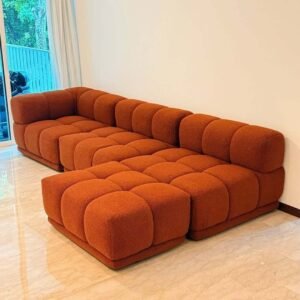 Rust orange tufted L shape sofa with chaise seating and textured upholstery for Kenya living rooms