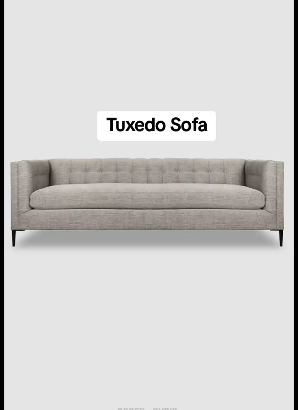 Grey tuxedo sofa with equal-height arms and back, button tufting, slim tapered dark legs