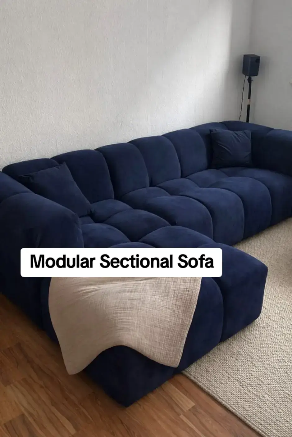Deep navy modular sectional bubble sofa — individual cushion modules arranged in L-configuration