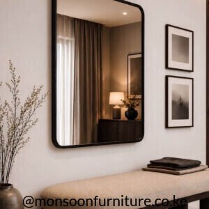 Black layered rectangular wall mirror Kenya with rounded corners mounted above a wooden entryway console.