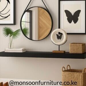 Black oval wall mirror Kenya with a slim frame mounted above a wooden entryway console.