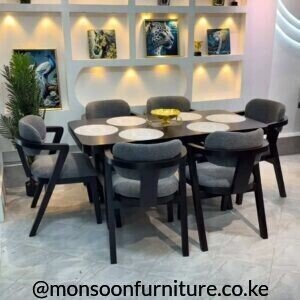 Charcoal curved 6 seater dining set Kenya with upholstered dining chairs and rounded dining table.