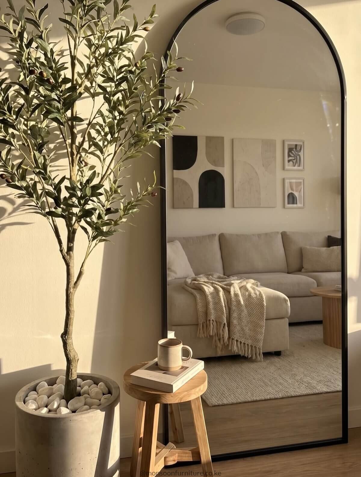 Gold arched full length mirror Kenya with a slim metallic frame, styled as a leaning bedroom floor mirror.
