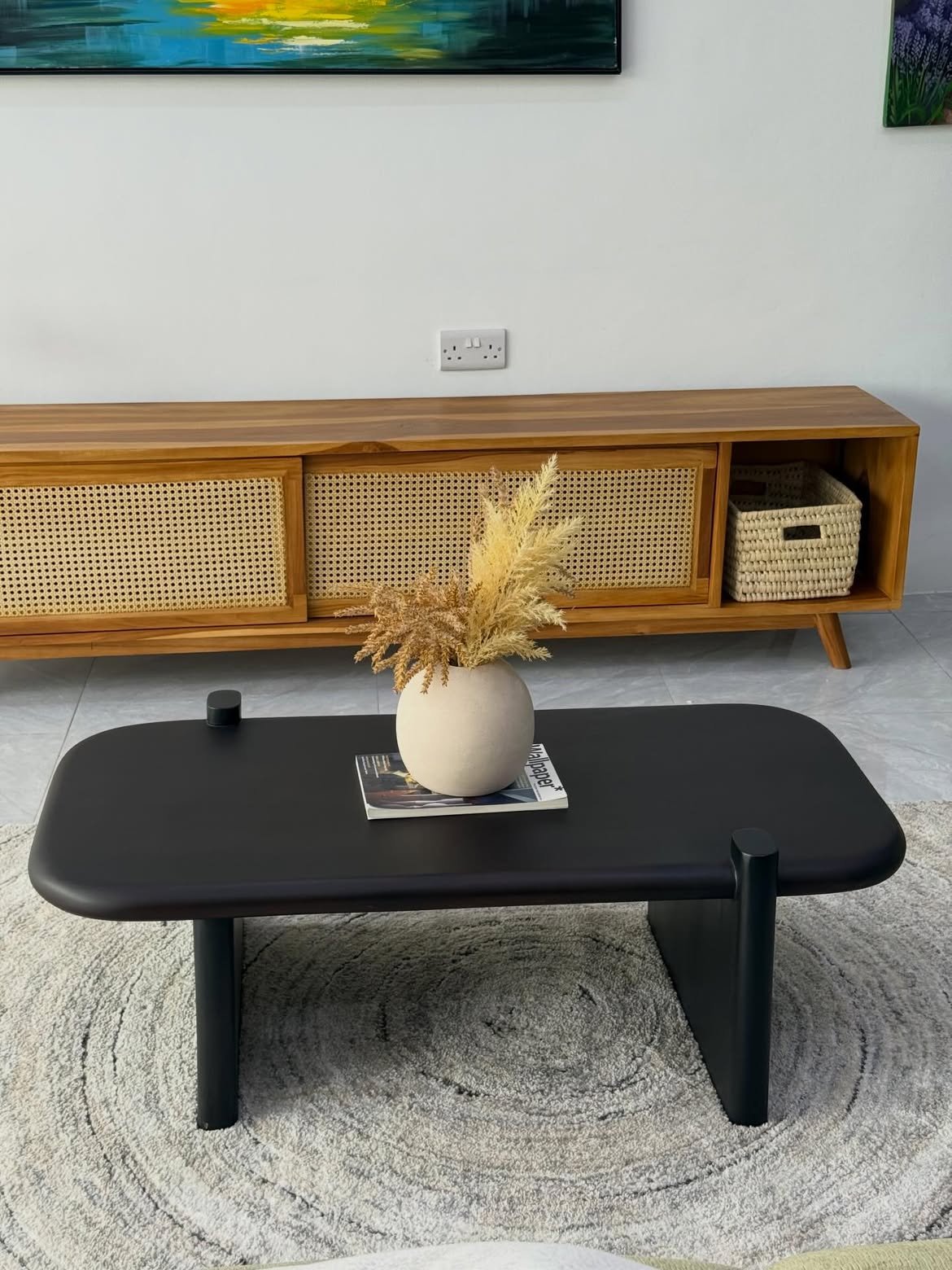 Matte black rounded coffee table Kenya with a thick rectangular top, broad panel legs and small raised corner posts.