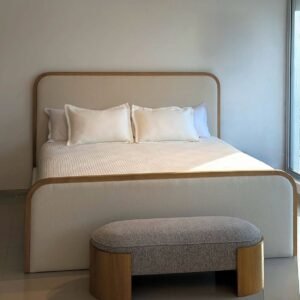 Cream upholstered rounded panel bed Kenya with a tall padded headboard, matching footboard and warm wood-look trim