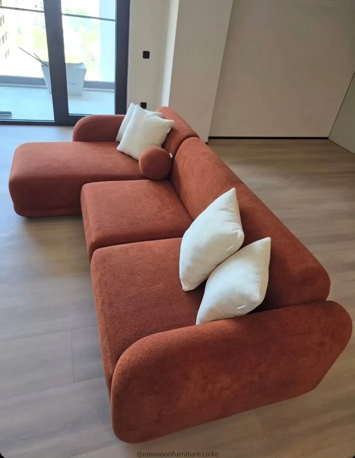 Terracotta curved modular L shape sofa with chaise for modern living rooms in Kenya