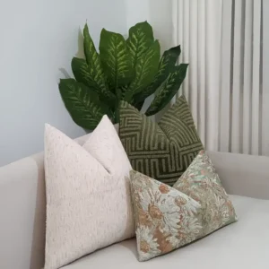 sage and cream throw pillow set with raised green geometry and muted floral accents in a Nairobi living room