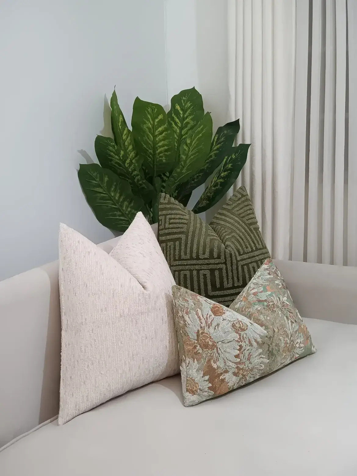 sage and cream throw pillow set with raised green geometry and muted floral accents in a Nairobi living room