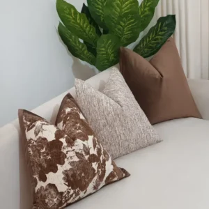 Five-piece taupe floral textured throw pillow set with brown botanical covers and neutral ribbed accents in Nairobi