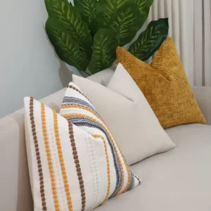 Six-piece mustard woven stripe throw pillow set with cream solids and textured ochre accents styled on a sofa in Nairobi