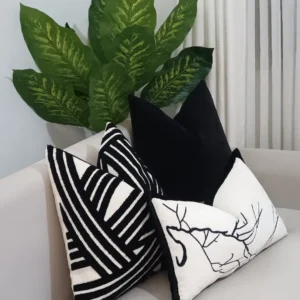 Four-piece black and white textured throw pillow set with stripes, abstract blocks, solid black and deer line art in Kenya