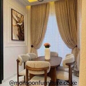 Walnut 6 seater oval solid hardwood dining set with cream boucle upholstered chairs in Kenya.