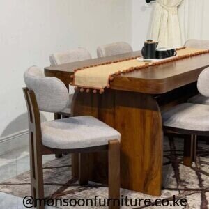Walnut modern 6 seater dining set with sculptural pedestal table and upholstered grey chairs in Kenya