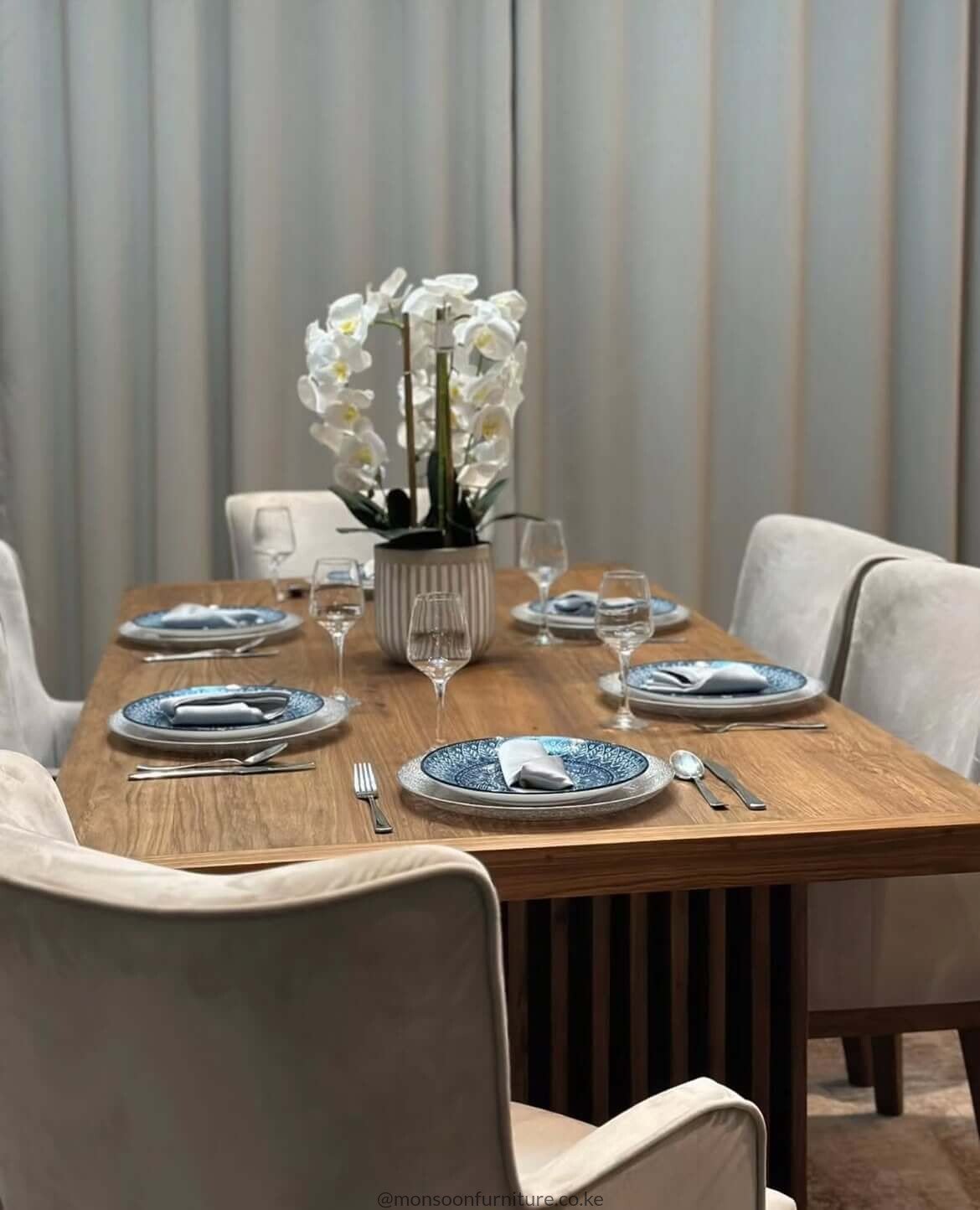 Walnut slatted pedestal 6 seater dining set Kenya with cream upholstered dining chairs.