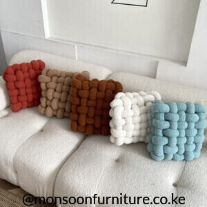 Terracotta, taupe, rust, ivory and light blue chunky basket-weave cushions and throw pillows styled on an ivory sofa in Nairobi