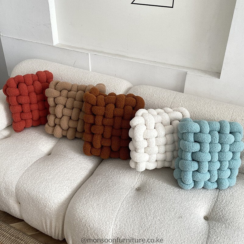 Terracotta, taupe, rust, ivory and light blue chunky basket-weave cushions and throw pillows styled on an ivory sofa in Nairobi