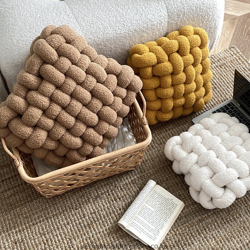Terracotta, taupe, rust, ivory and light blue chunky basket-weave cushions and throw pillows styled on an ivory sofa in Nairobi