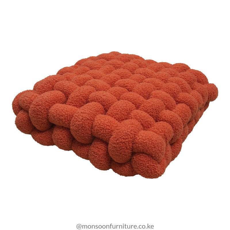 Terracotta, taupe, rust, ivory and light blue chunky basket-weave cushions and throw pillows styled on an ivory sofa in Nairobi