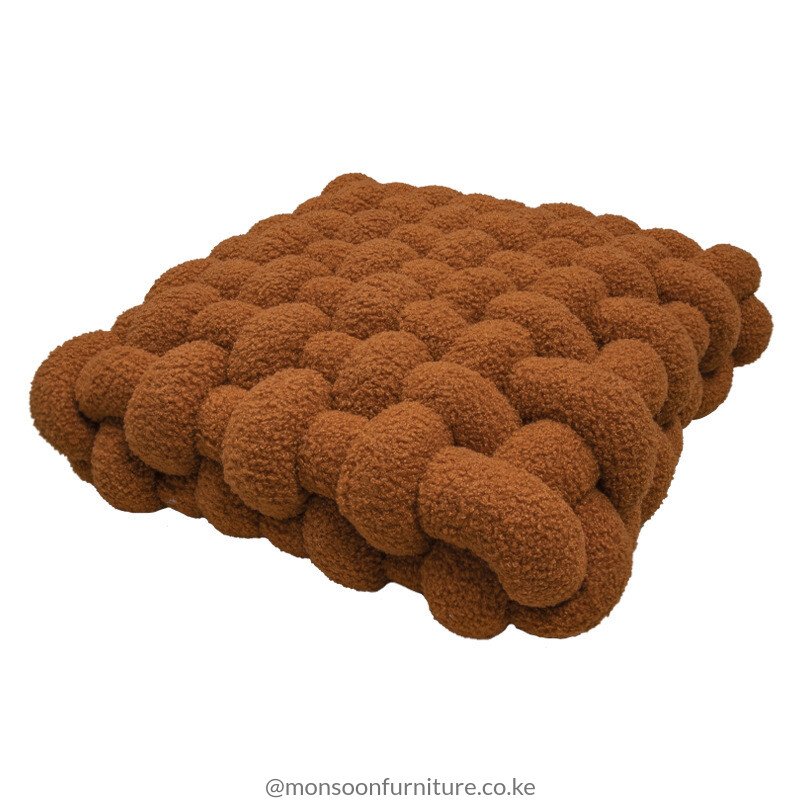 Terracotta, taupe, rust, ivory and light blue chunky basket-weave cushions and throw pillows styled on an ivory sofa in Nairobi
