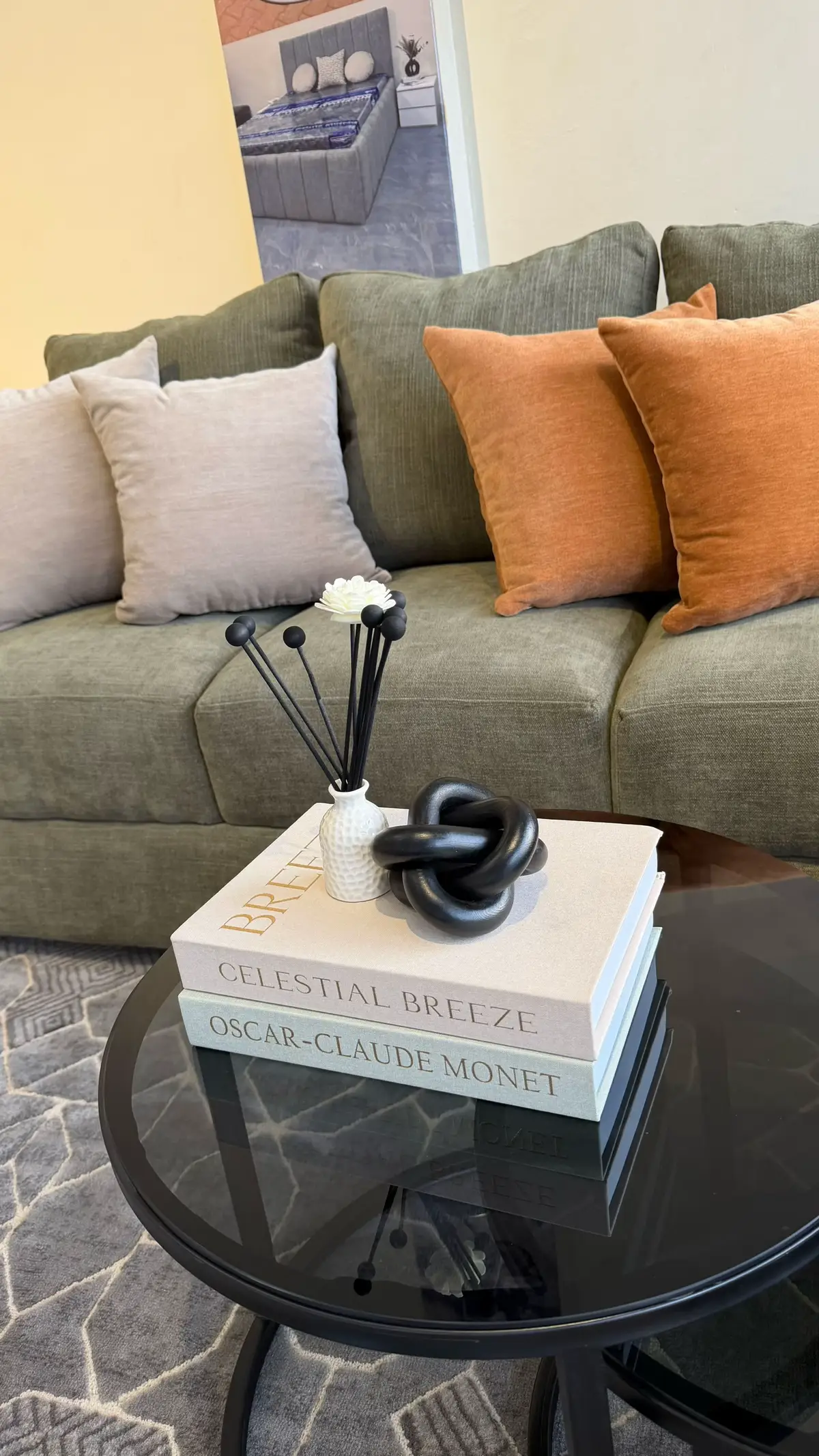 Coffee table vignette with candles, a vase, and a decorative bowl grouped together