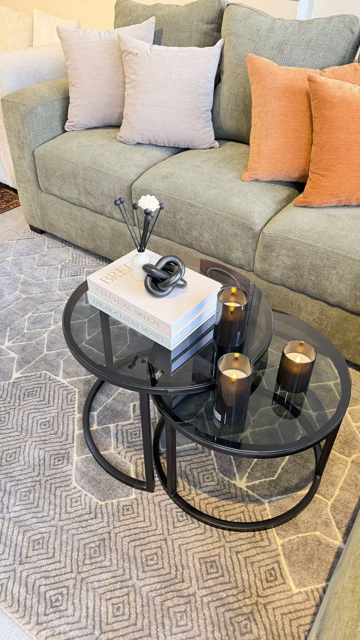 Rectangular coffee table styled with two vignette groupings across its length