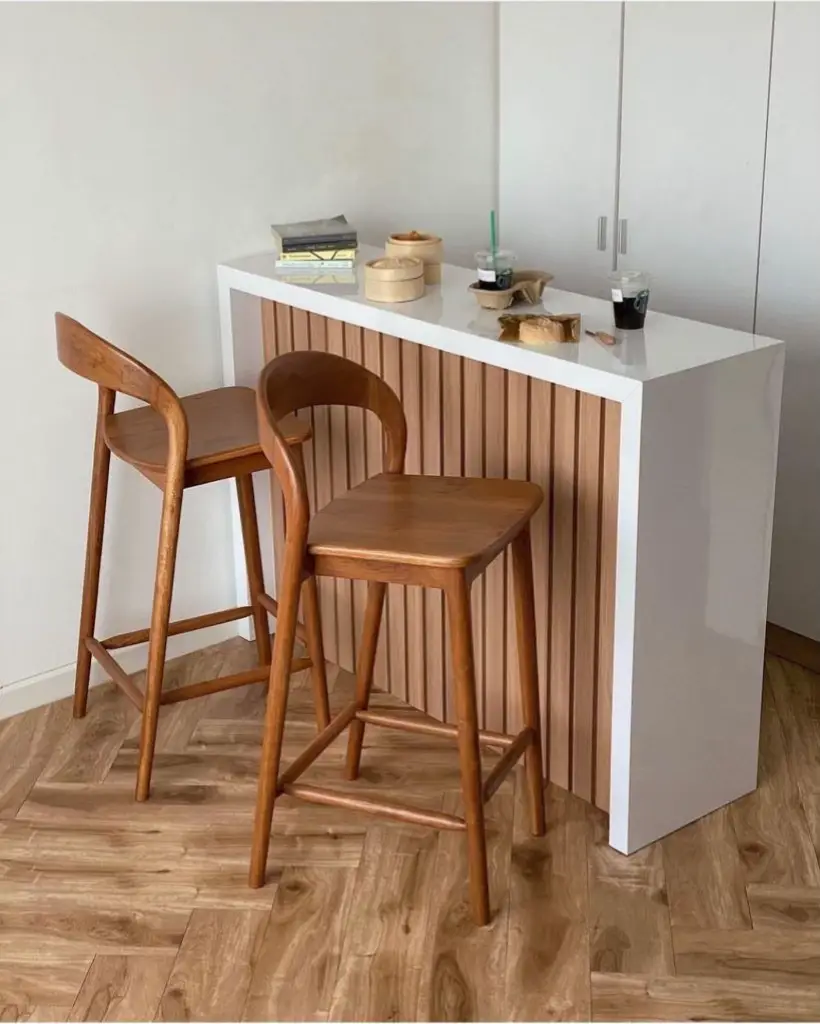 Bar stools with backrests and backless stools compared in a Kenyan kitchen