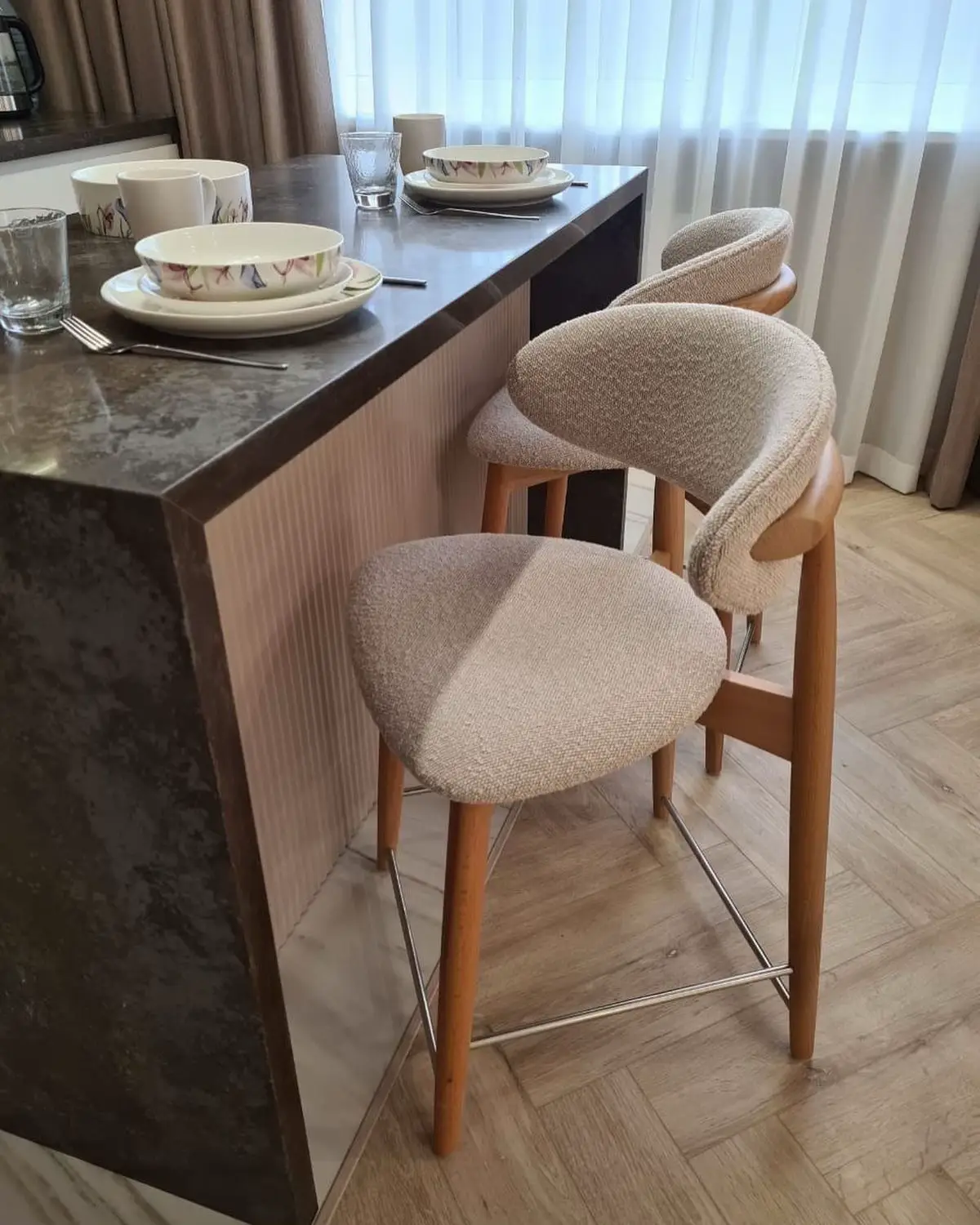 Row of bar stools correctly spaced along a kitchen island counter