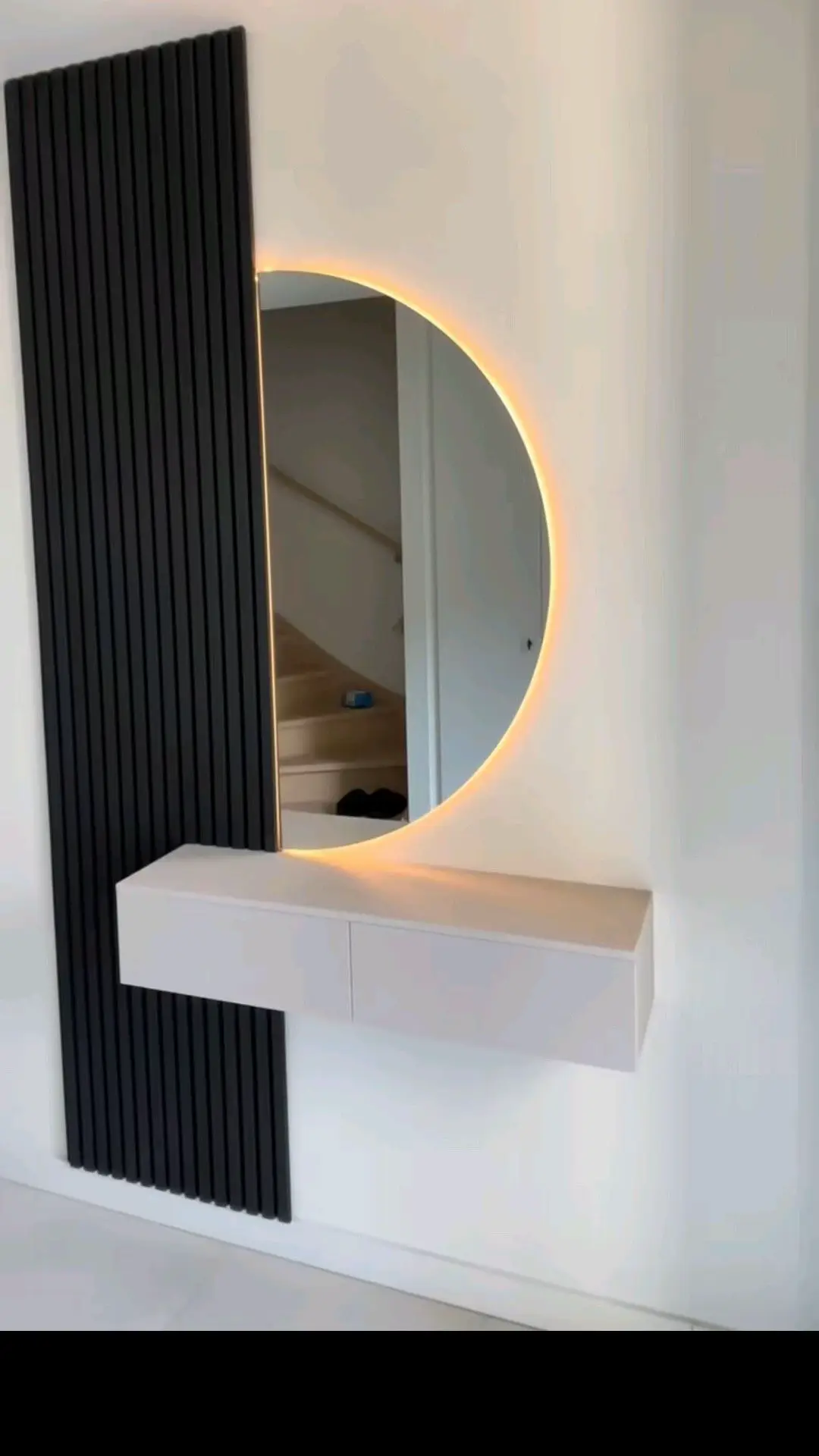Round decorative wall mirror above a console table in a modern Kenyan living room