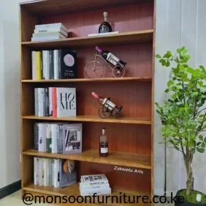 Tall Muninga hardwood bookshelf in a warm brown finish with five open display levels beside a potted plant.