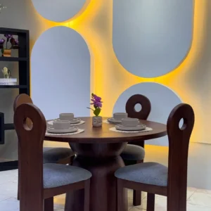 4 seater Muninga wood dining set with round dark wood table and four grey upholstered chairs