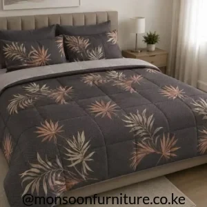 quilted duvet with cream and muted rust leaf motifs and a light-grey reverse on a bed.