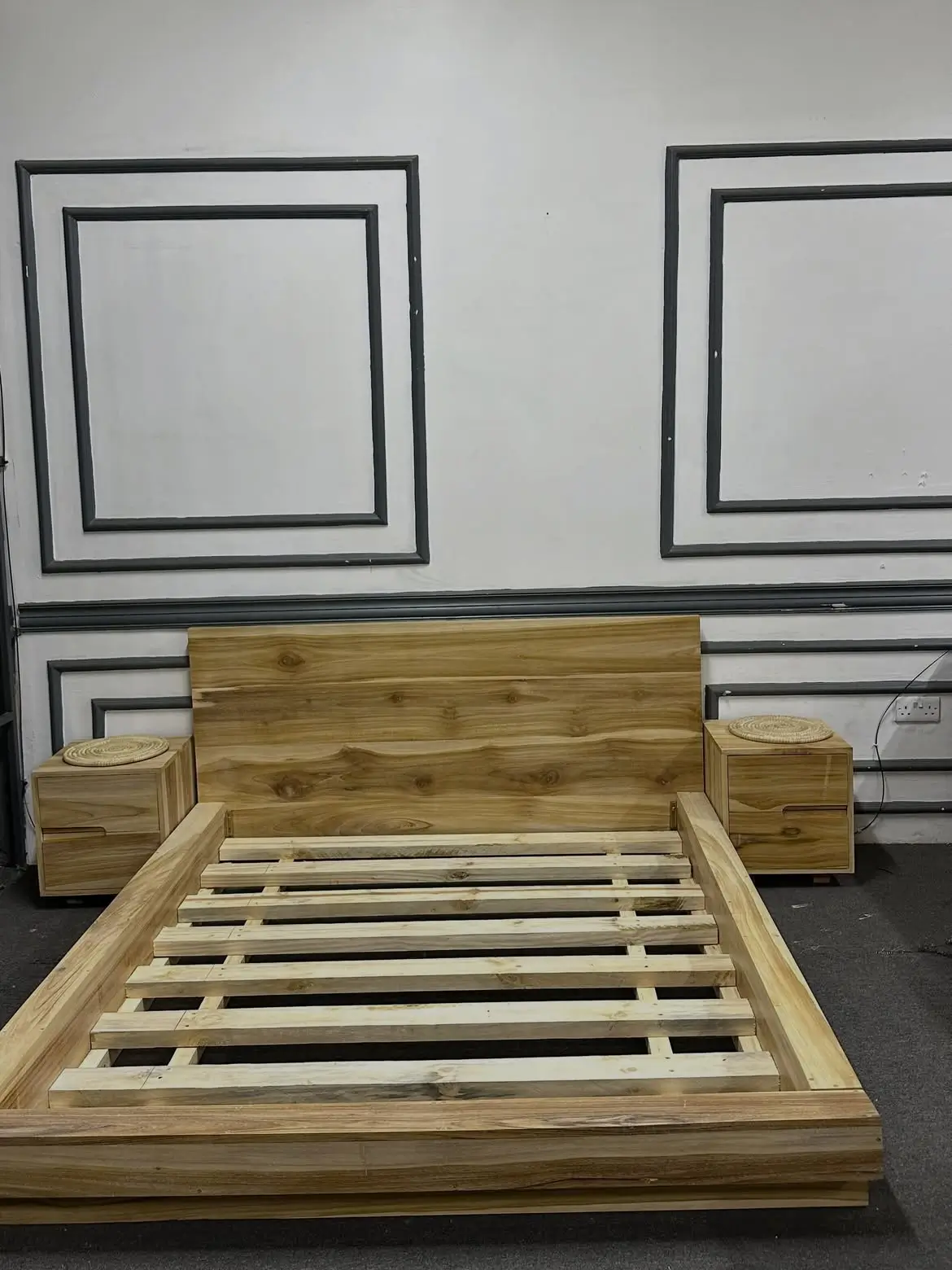 5×6 natural wood-look panel bed with broad rectangular headboard and visible slatted mattress base