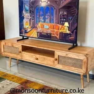 AnJulie solid wood TV console with woven side doors, central open shelf, rounded corners and tapered wooden legs.