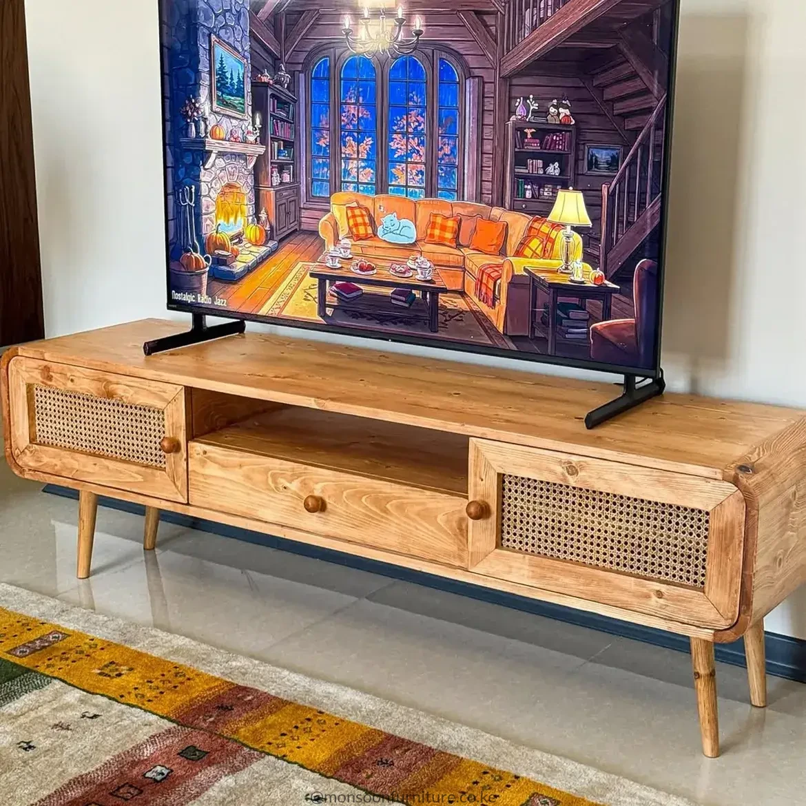 AnJulie solid wood TV console with woven side doors, central open shelf, rounded corners and tapered wooden legs.