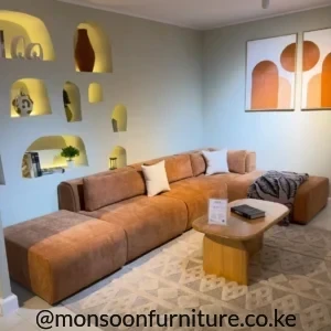Caramel brown low-profile modular sectional sofa with chaise-style extension in a modern living room