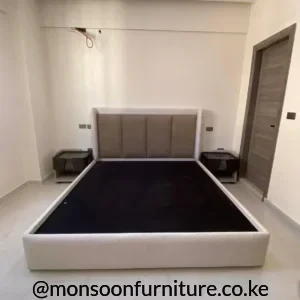 Cream upholstered bed with four beige vertical headboard panels, rounded side borders and matching padded footboard.