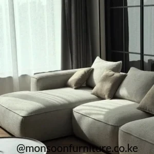 ight beige modular sectional sofa with deep seat platforms, loose back cushions and low wide arms in a modern living room.