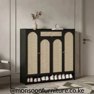Black four-door shoe cabinet with light arched woven panels, a woven-front drawer and an open lower shelf holding shoes.