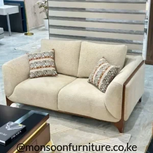 Cream bouclé 2 seater sofa with exposed wooden frame and curved arms for modern homes