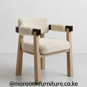 Cream textured upholstered dining armchair with padded arms, light wood-tone legs and dark brown rail accents.