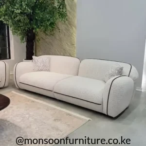 Ivory bouclé 3 seater curved sofa with black piping for modern luxury living rooms