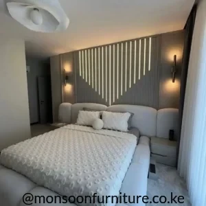 Light grey curved upholstered bed with oversized padded headboard for modern bedrooms