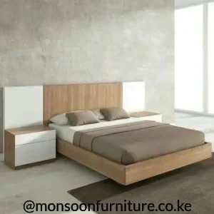 Light wood-grain bed with wide white-accent headboard, low frame and two coordinated bedside units in a bright bedroom.