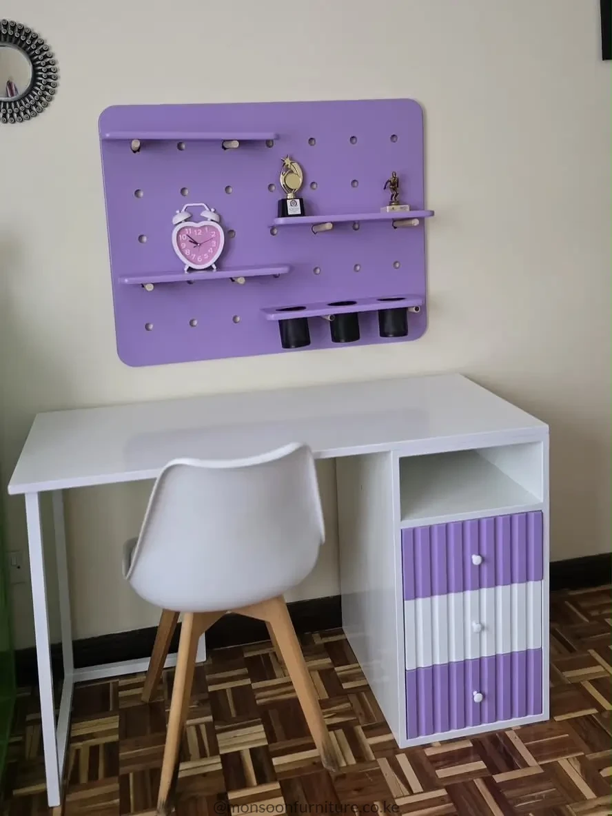 Purple and white study desk with three drawers, open cubby and matching wall organizer with shelves and hanging cups.