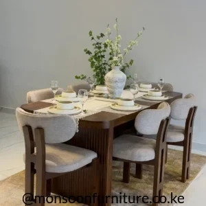 Six-seater dark wood dining table with six cream upholstered chairs