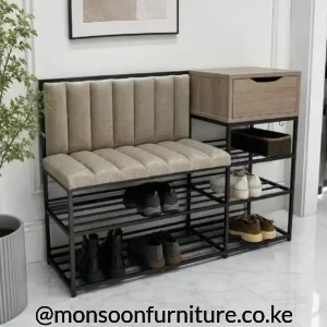 Black-framed entryway bench with beige channelled cushions, open shoe shelves and a wood-look drawer on the right.