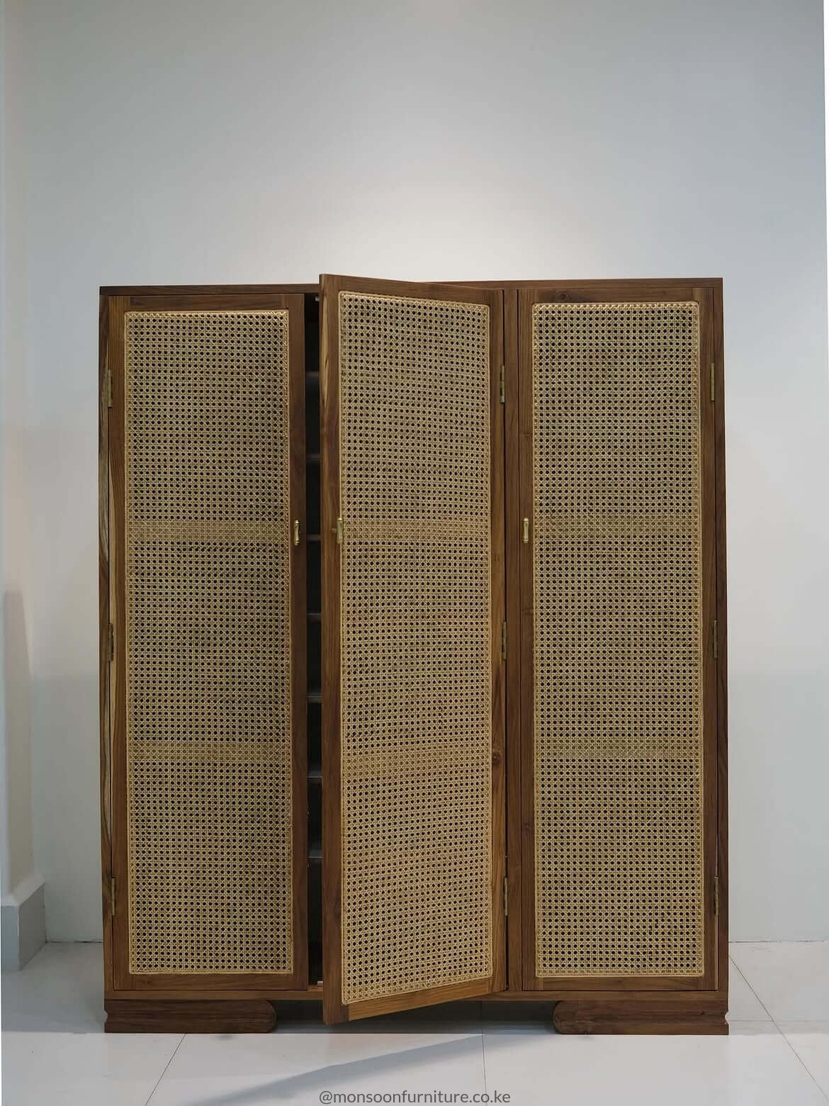 Wooden shoe cabinet in teak with brass-tone handles for a Nairobi home